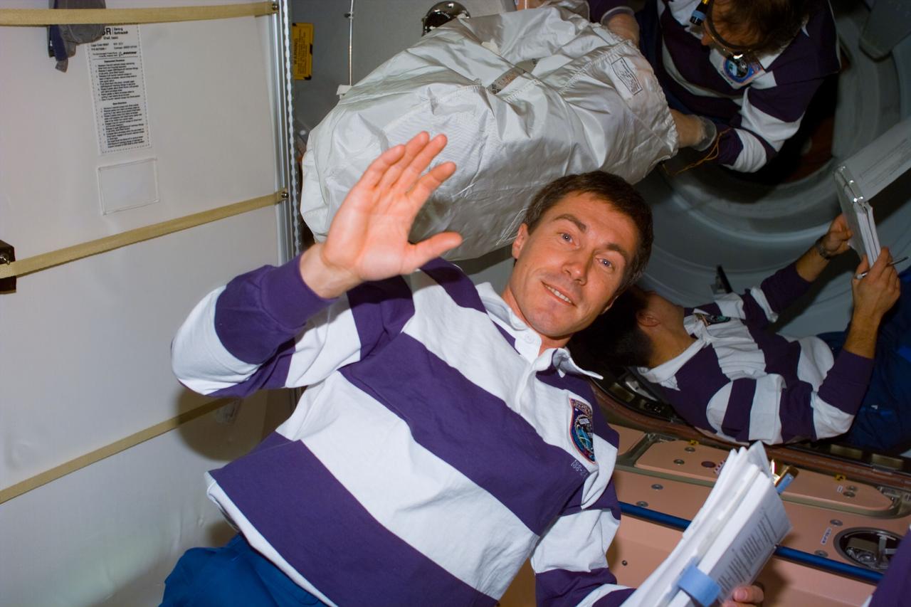 S88-E-5113 (12-10-98) --- Sergei Krikalev, mission specialist representing the Russian Space Agency (RSA), totes a notebook onboard the Unity connecting module while he and two crewmates perform various tasks to ready it for its ISS role. The photo was taken with an electronic still camera (ESC) at 20:27:03 GMT, Dec. 10.