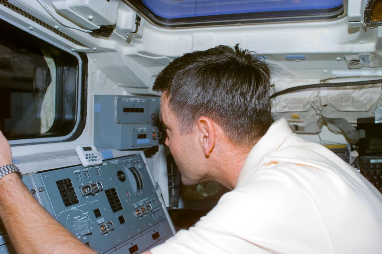 S88-E-5149 (12-13-98) --- Astronaut Robert D. Cabana, STS-88 mission commander, looks toward the mated Russian-built Zarya and the U.S.-built Unity module in Endeavour's cargo bay several hours prior to release of the ISS components. The photo was taken with an electronic still camera (ESC) at 05:11:47 GMT, Dec. 13.