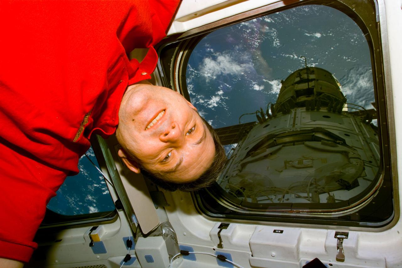 S88-E-5155 (12-13-98) --- Astronaut Robert D. Cabana, mission commander, floats near the ceiling of Endeavour's aft flight deck. Seen through overhead windows are the mated Zarya and Unity modules before the ISS components were released from Endeavour's cargo bay. The scene was recorded with an electronic still camera (ESC) at 19:33:57 GMT, Dec. 13.