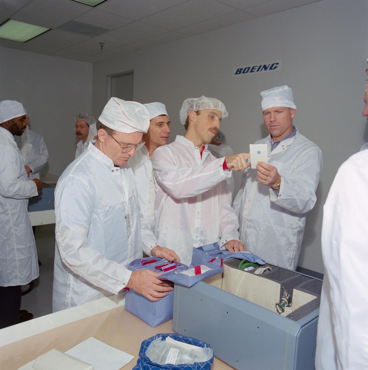 S89-26240 (20 Jan 1989) --- Four of the five STS-29 crewmembers inspect the content of their emergency medical and medication kits during the recent bench review of middeck locker equipment avaialable for their scheduled March 1989 flight. From left to right are Astronauts James H. Buchli,   John E. Blaha, James P. Bagian and Michael L. Coats.  Not pictured is Robert C. Springer.
