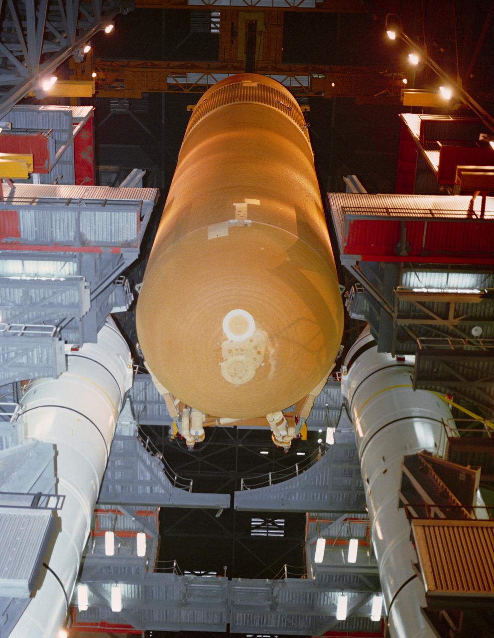 S89-27380 (15 Dec 1988) --- The 155-ft. long external fuel tank (ET) is slowly lowered for   mating with the twin solid rocket boosters (SRB) in Bay 1 of the Vehicle Assembly Building at KSC, as preparations continue for a March 1989 launch of Discovery. Primary payload for the mission will be the tracking and data relay satellite (TDRS-D).  Crewmembers are astronauts Michael L. Coats, John E. Blaha, James F. Buchli, Robert C. Springer and James P. Bagain.