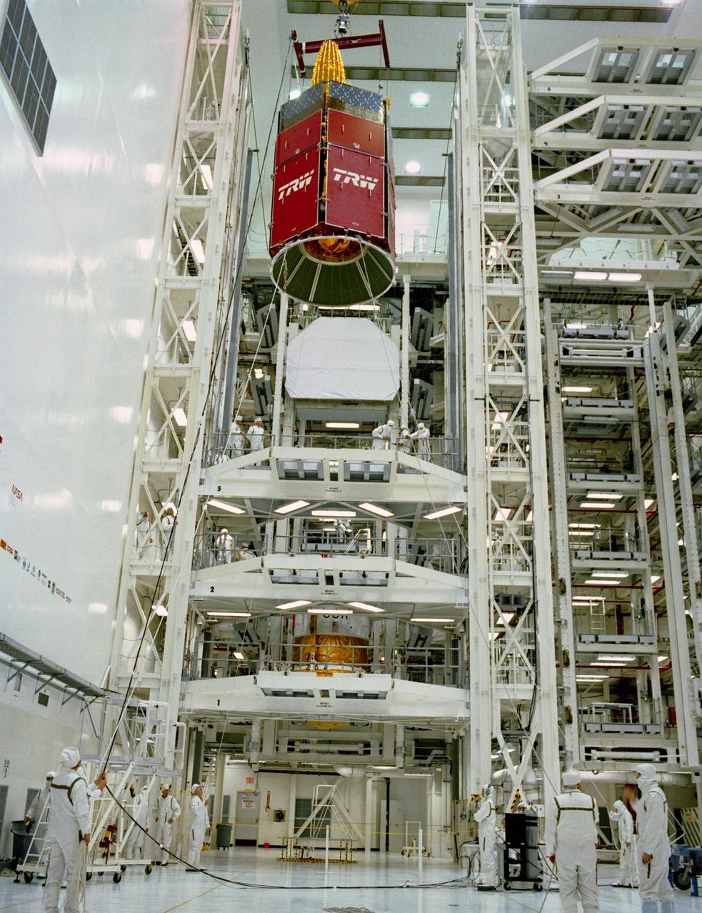 S89-27383 (29 Dec 1988) --- This wide shot of a test cell in KSC's Vertical Processing Facility affords an overall scene of the mating process of the STS 29 tracking and data relay satellite (TDRS-D, in foreground) with  its inertial upper stage (IUS-9, in lower part of frame).  Later the tandem will be   loaded into the cargo bay of Discovery.