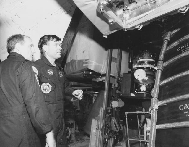NASA image: STS-29 crewmembers inspect Discovery, OV-103, main engine components at KSC