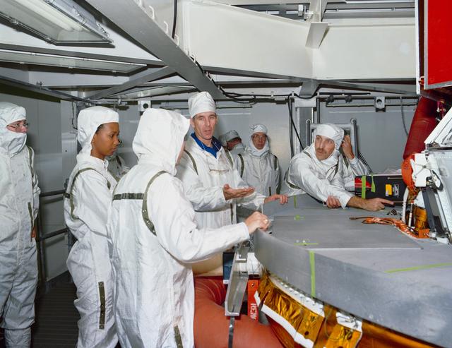 NASA image: STS-29 crewmembers inspect TDRS-D inertial upper stage (IUS) at KSC VPF