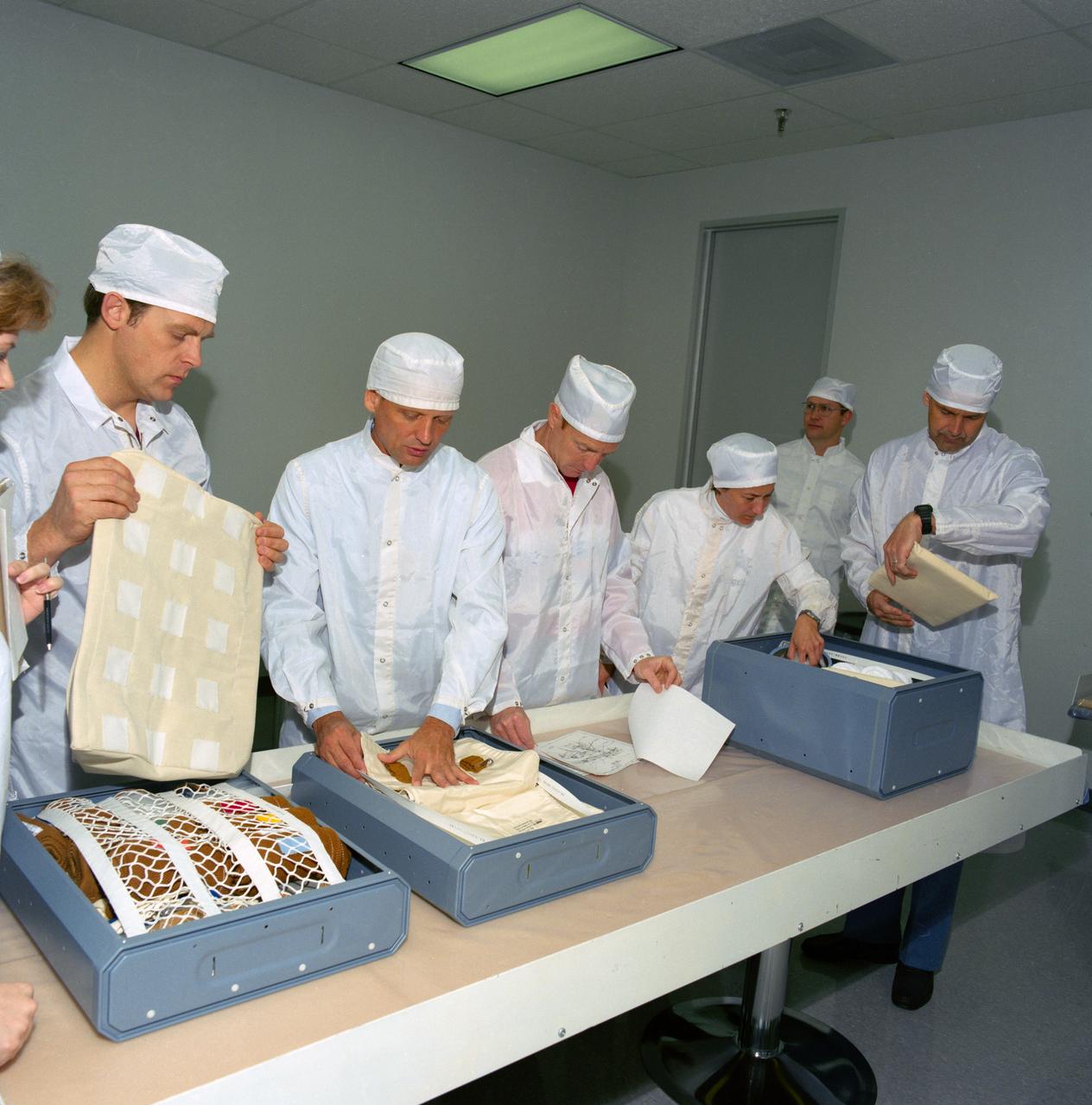 S89-30260 (31 March 1989) --- The five astronaut crewmembers for NASA's STS-30 mission conduct a bench review of the actual supplies they will be depending on for use aboard the Atlantis when they spend four days in space later in the spring.  Left to right are Astronauts Mark C. Lee, mission specialist; Norman E. Thagard, mission specialist; David M. Walker, mission commander;  and Mary L. Cleave, mission specialist. Ronald J. Grabe, pilot, is at far right.