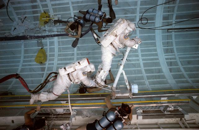 NASA image: STS-37 crewmembers work with CETA during EVA training in JSC's WETF