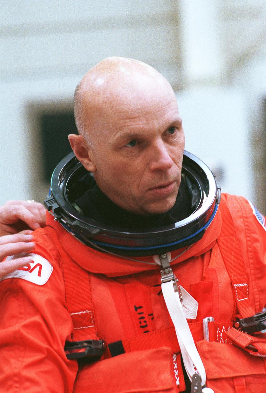 S89-48009 (29 Oct. 1996) --- About to embark on his sixth shuttle flight, astronaut Story Musgrave receives assistance with his launch and entry suit during a training session in the Johnson Space Center's (JSC) Shuttle Mockup and Integration Laboratory (SMIL).