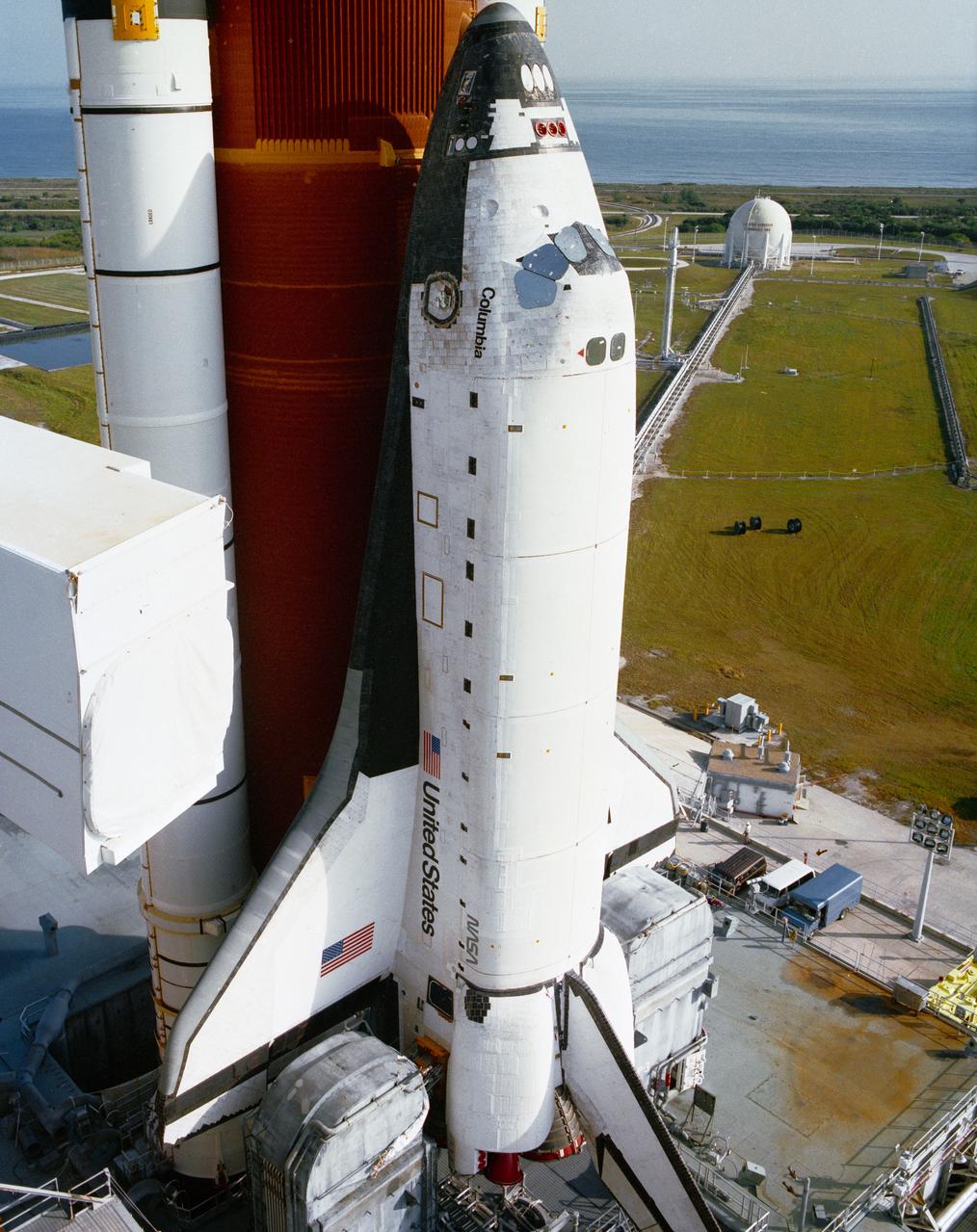 S89-51983 (18 Nov 1989) --- Roll-out of the Space Shuttle Columbia is completed as the vehicle, atop the Mobile Launcher Platform, is positioned on the hard stand at Pad 39A. The approximately eight-hour journey from the Vehicle Assembly Building began at 2:32 a.m. EST. This marks the first time a Space Shuttle has been at Pad A at Launch Complex 39 since January 12, 1986, when Columbia was launched on mission 61C. Pad A will next be used for the launch of Columbia and a five person crew on the STS-32 mission, presently scheduled for no earlier than December 18, 1989.