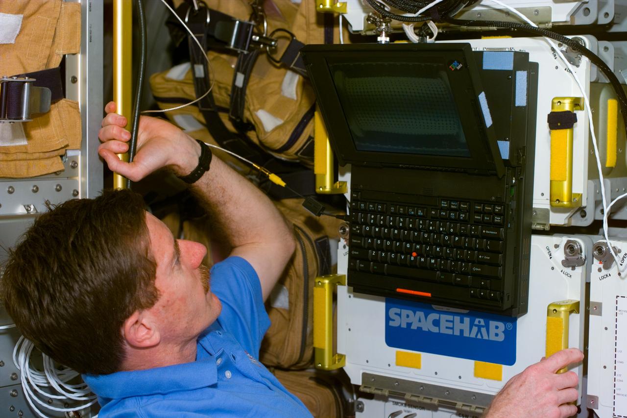 S89-E-5196 (25 Jan 1998) --- This Electronic Still Camera (ESC) image shows astronaut James F. Reilly, mission specialist, using a lap top computer in the Spacehab Double Module (DM), onboard the Space Shuttle Endeavour.  This ESC view was taken on January 25, 1998 at 17:06:16 GMT.