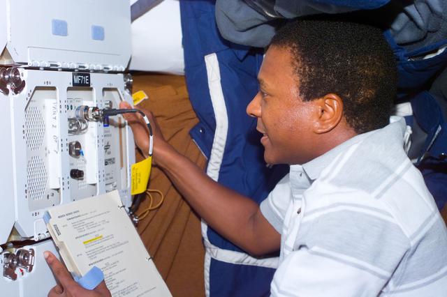 NASA image: CEBAS - MS Anderson works with three middeck payloads