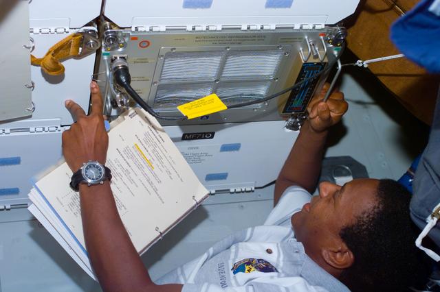 NASA image: MS Anderson works with three middeck payloads