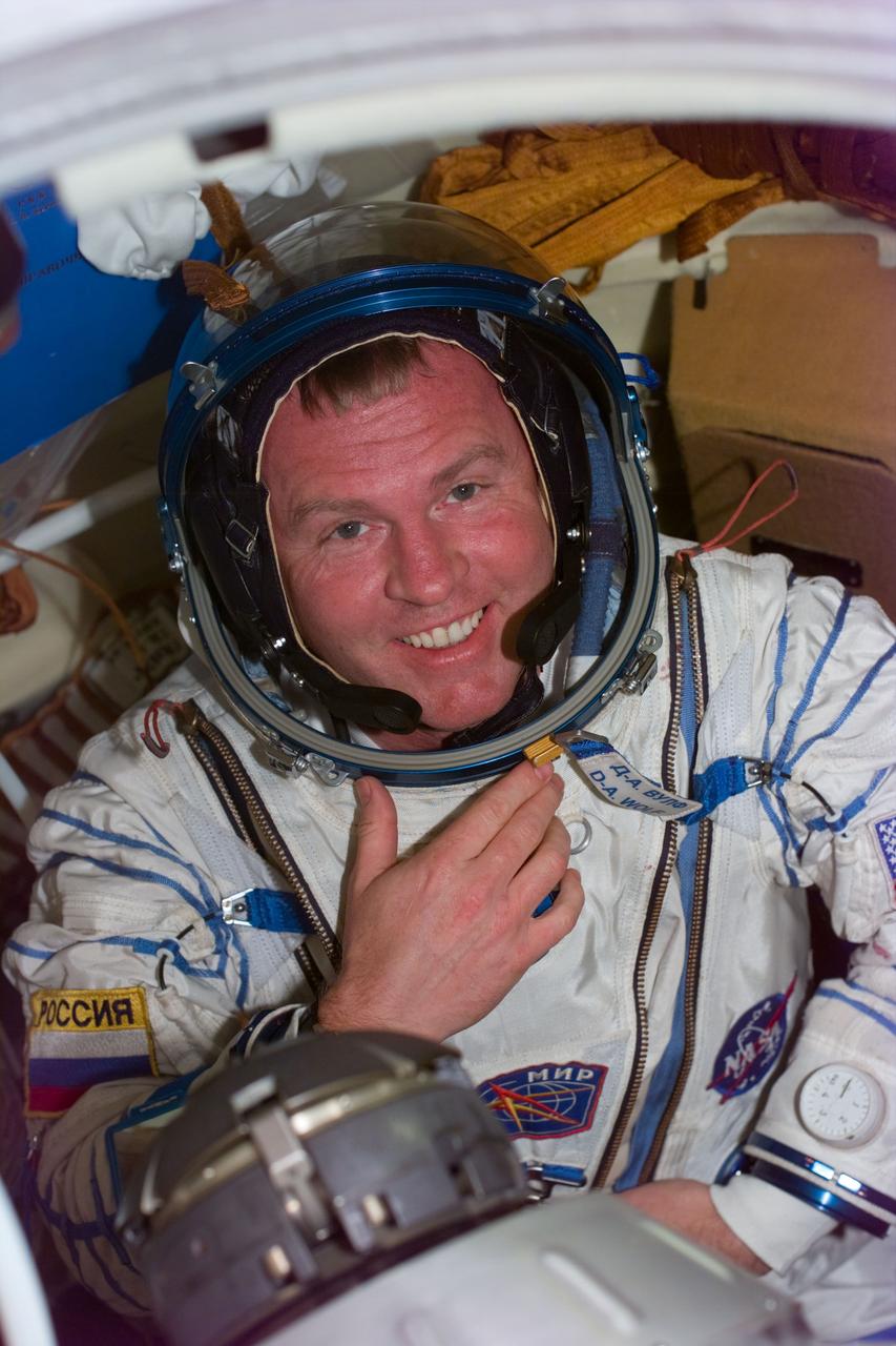 S89-E-5216 (25 Jan 1998) --- This is the second of a series of three photos onboard Russia's Mir Space Station showing Andrew S. W. Thomas following the donning of the Sokol spacesuit of David A. Wolf, who has been onboard Mir since September 1997.  An earlier fit check of Thomas' Sokol suit did not initially meet specifications required in the event he has to spend time in the pressurized Soyuz spacecraft, now docked to Mir.  After Thomas was checked out in Wolf's suit, sizing modifications were made to his own suit and it was then verified for use by Thomas in the event of a contingency. The image was taken with an Electronic Still Camera (ESC) at 17:59:00 GMT, January 25, 1998.