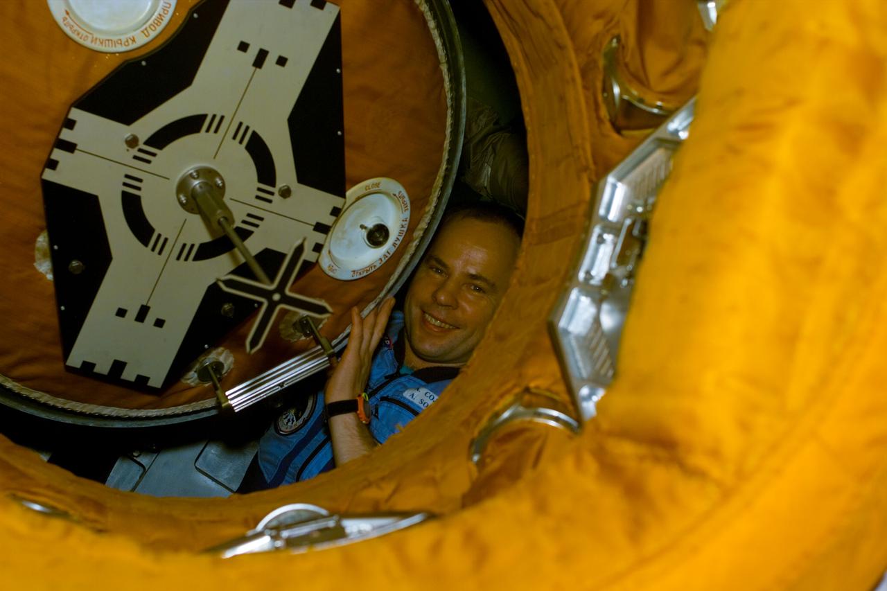 S89-E-5359 (28 Jan 1998) --- This Electronic Still Camera (ESC) image shows cosmonaut Anatoliy Y. Solovyev, Mir-24 commander, peeking through the Docking Module (DM) hatch one last time to bid his astronaut friends farewell, just moments before final hatch closure.  The hatch closing brings an end to the eighth Shuttle/Mir joint docking activities.  The STS-89 crew, onboard the Space Shuttle Endeavour, dropped off astronaut Andrew S. W. Thomas to replace astronaut David A. Wolf, as cosmonaut guest researcher.  Thomas will be the last American astronaut to serve a tour aboard the Russian Mir Space station.  This ESC view was taken on January 28, 1998, at 22:30:54 GMT.