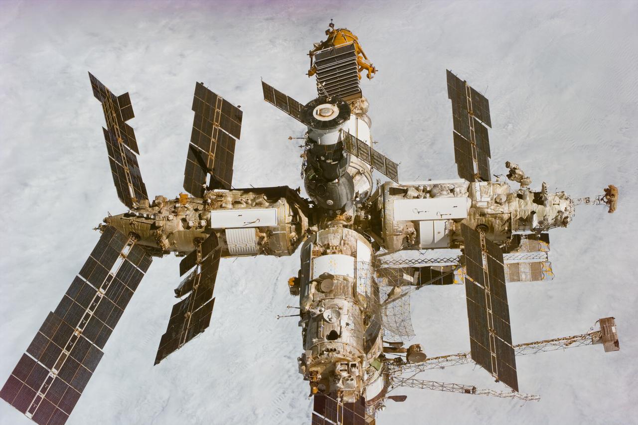 S89-E-5520 (22-31 Jan 1998) --- This Electronic Still Camera (ESC) image shows Russia?s Mir Space Station backdropped over clouds, not long after separation from the Space Shuttle Endeavour.  Thus bringing to an end the eighth Shuttle/Mir docking mission activities.  (Please note that this series of post-separation views is not posted here in chronological order because of the use of a second ESC.  Note also that GMT times were not available for all images.)