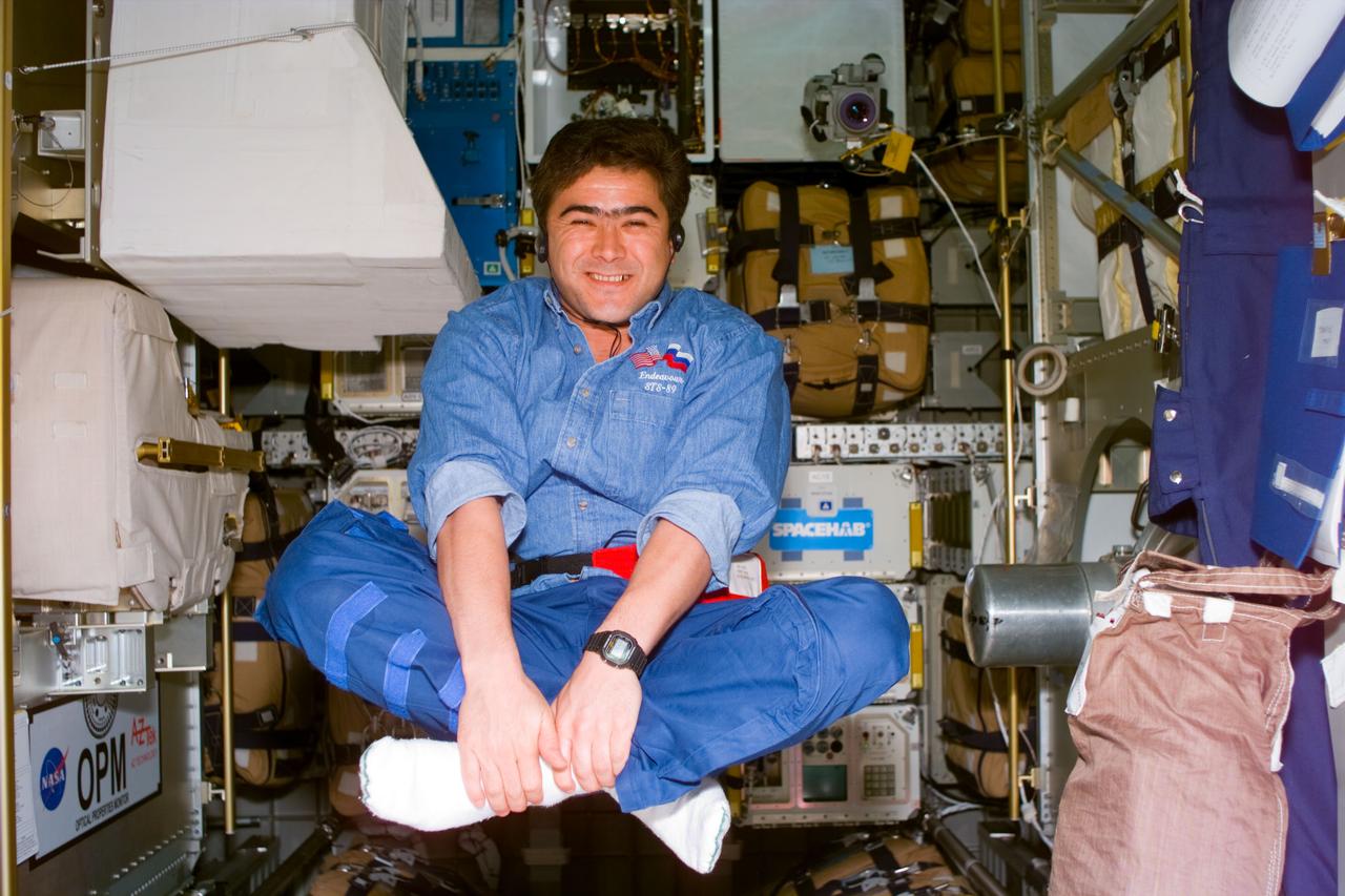 S89-E-5524 (22-31 Jan 1998) --- This Electronic Still Camera (ESC) image shows Salizan Sharipov, mission specialist representing Russia's Space Agency (RSA), takes advantage of the weightless environment of Earth-orbit to relax in the Spacehab Module during off-duty time on the Space Shuttle Endeavour. This ESC view was taken at 01:29:11 GMT, on January 30, 1998.
