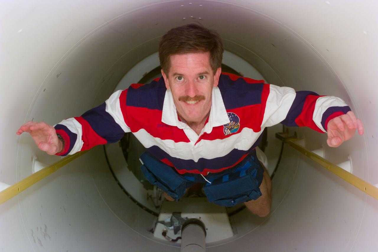 S89-E-5534 (22-31 Jan 1998) --- This Electronic Still Camera (ESC) image shows astronaut James F. Reilly, mission specialist, floating in the tunnel connecting the Spacehab module to the mid-deck of the Earth-orbiting Space Shuttle Endeavour.  Having disconnected from the Russian Mir Space Station a day earlier, the STS-89 crew was in a mode of wrapping up final chores before a scheduled January 31st landing.