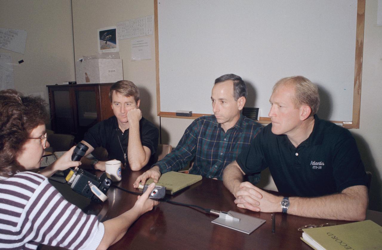 STS-38 crewmembers listen as RSOC-JSC crew trainer M. Judy Alexander explains the camera equipment they will be using on their upcoming Department of Defense (DOD) mission. Left to right are Pilot Frank L. Culbertson, Mission Specialist (MS) Carl J. Meade, and MS Charles D. Gemar. Alexander is holding a training version of the 70mm handheld HASSELBLAD camera.