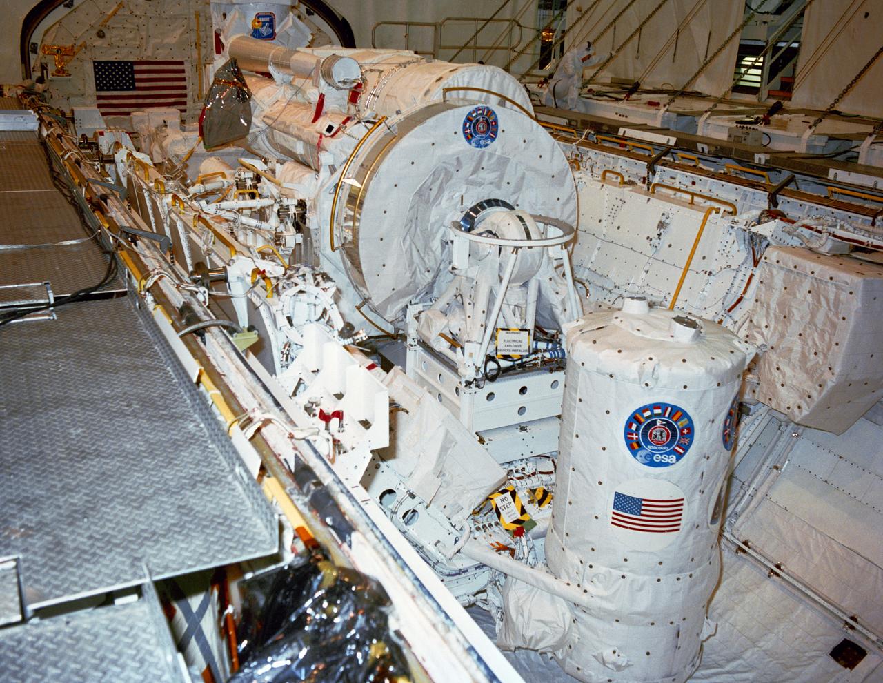 S90-36708 (7 May 1990) ---  STS-35 Astronomy Laboratory 1 (ASTRO-1) view shows its telescopes, instrument pointing system (IPS), and support equipment installed in Columbia's, Orbiter Vehicle (OV) 102's, payload bay (PLB) at the Kennedy Space Center (KSC) Orbiter Processing Facility (OPF). In the foreground is the Spacelab Pallet System (SPS) igloo. The stowed IPS with its three ultraviolet telescopes appears in the center of the picture. In the background, the Broad Band X Ray Telescope (BBXRT) two axis pointing system (TAPS) is barely visible. View provided by KSC with alternate number KSC-90PC-423.