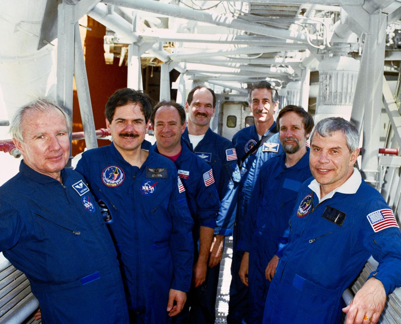 S90-38029 (21 May 1990) --- STS-35 Columbia, Orbiter Vehicle (OV) 102, crewmembers commander Vance D. Brand, pilot Guy S. Gardner, mission specialists Jeffrey A. Hoffman, John M. Lounge, Robert A. R. Parker, payload specialists Samuel T. Durrance and Ronald A. Parise and backup payload specialist Kenneth Nordsieck take a break from training activities and pose on the 195-Floor Level on Launch Pad 39A at the Kennedy Space Center (KSC). On left from front to back are Brand, Parise, Lounge and Gardner and on right from front to back are Parker, Nordsieck, and Hoffman. View provided by KSC with alternate number KSC-90PC-670.