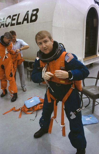 NASA image: STS-38 crewmembers don LES equipment prior to egress training in JSC's MAIL