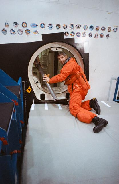 NASA image: STS-38 MS Springer climbs through CCT side hatch prior to egress training