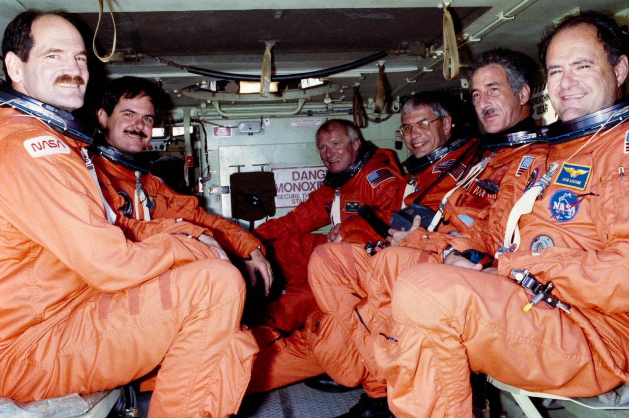 S90-40670 (13 June 1990) --- STS-35 crewmembers take a ride in the M113 tracked vehicle during emergency training conducted during the Terminal Countdown Demonstration Test (TCDT) at the Kennedy Space Center (KSC). From left, wearing launch and entry suits (LES), are pilot Guy S. Gardner, payload specialist Ronald A. Parise, commander Vance D. Brand, mission specialists Robert A. R. Parker, Jeffrey A. Hoffman and John M. Lounge. The two-day TCDT, which began 04-27-90, is a dress rehearsal for launch. STS-35 is set to lift off in May. View provided by KSC with alternate number KSC-90PC-838.