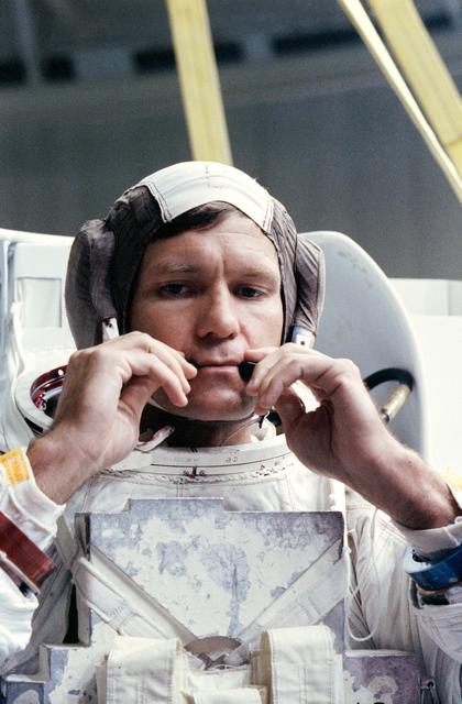 NASA image: STS-39 MS McMonagle adjusts CCA microphones prior to simulation in JSC's WETF