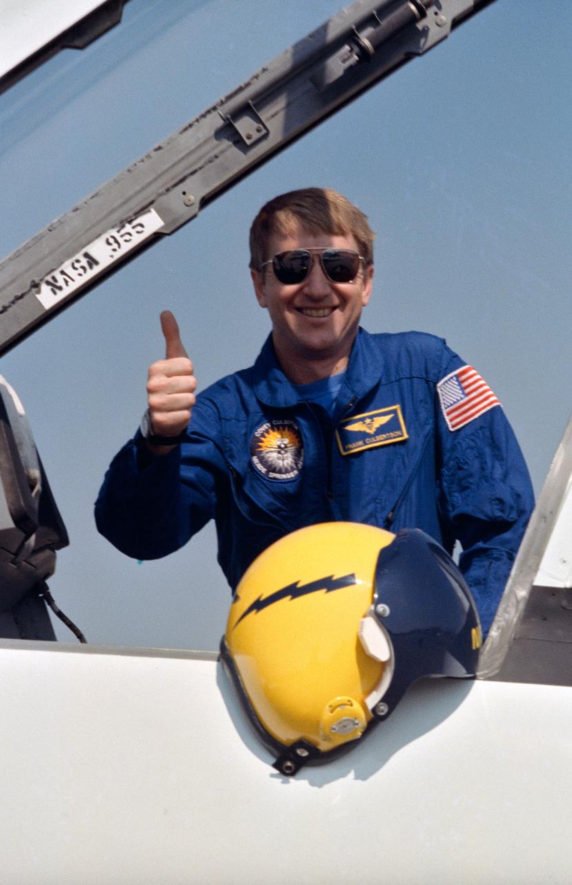STS-38 Pilot Frank L. Culbertson gives "thumbs up" before climbing into the T-38A NASA 955 forward cockpit. Crewmembers are preparing for departure from Ellington Field to the Kennedy Space Center (KSC). Culbertson's bright yellow helmet is displayed in front of him.