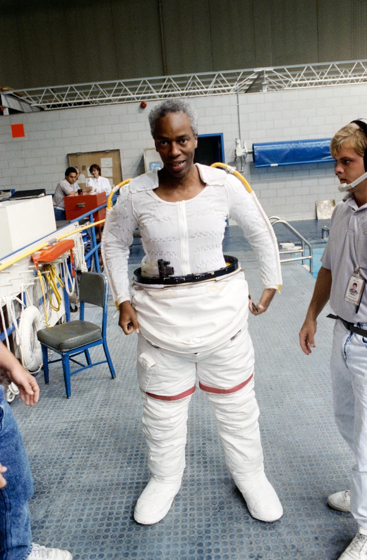 Guy Bluford puts on an EMU astronaut suit.