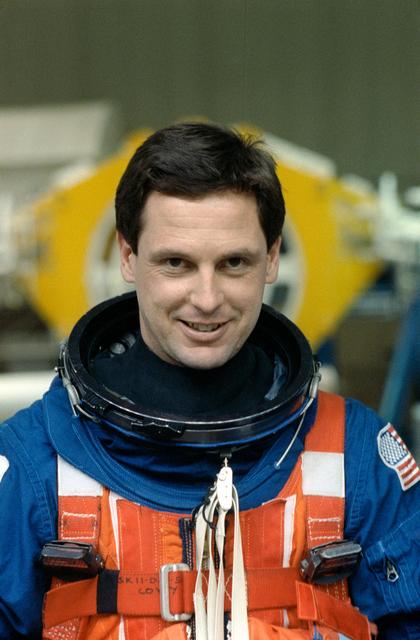 NASA image: STS-39 MS Harbaugh listens to emergency egress instructions at JSC's WETF