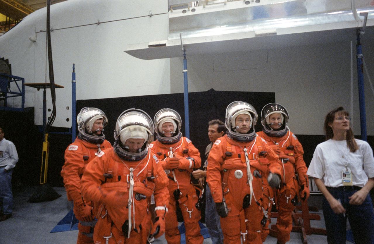 S91-43614 (25 July 1991) --- The astronaut crewmembers for NASA's STS 48 mission, attired in orange partial pressure garments used for Shuttle launch and entry, prepare to participate in an emergency egress training session at the Johnson Space Center.  The crewmembers are, left to right, astronauts Mark N. Brown, James F. Buchli and Charles D. (Sam) Gemar, all mission specialists, and John O. Creighton, Mission commander, and Kenneth S. Reightler, pilot.  STS 48 is currently scheduled for mid-September of this year.
