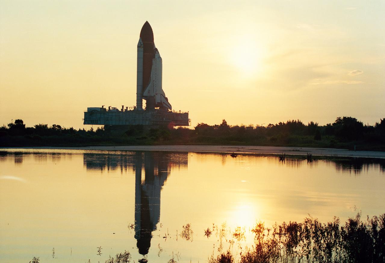 S91-44810 (12 Aug 1991) --- The Space Shuttle Discovery is rolled to launch pad 39A atop the mobile launcher platform and crawler/transporter.  Already at the pad and awaiting installation in the orbiter cargo bay is the Upper Atmosphere Research Satellite (UARS), the primary payload which Discovery will carry into space on NASA?s STS-48 mission.  A crew of five astronauts will be on board when Discovery lifts off in September. (KSC photo id: KSC-91PC-1474)