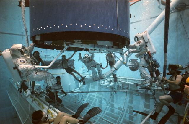 NASA image: STS-49 INTELSAT VI-R WETF exercise with astronauts Musgrave, Clifford, Voss