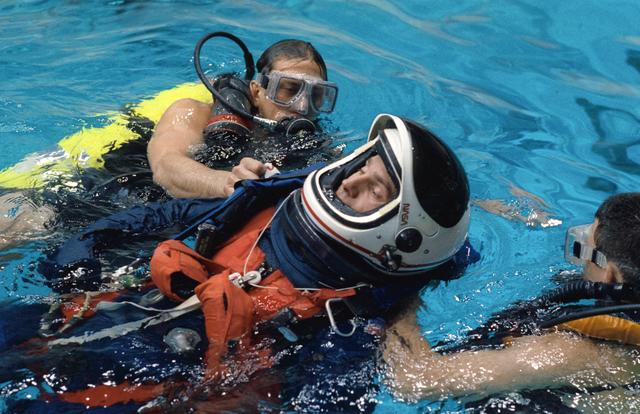 NASA image: STS-52 Payload Specialist MacLean floats in pool during JSC bailout exercises