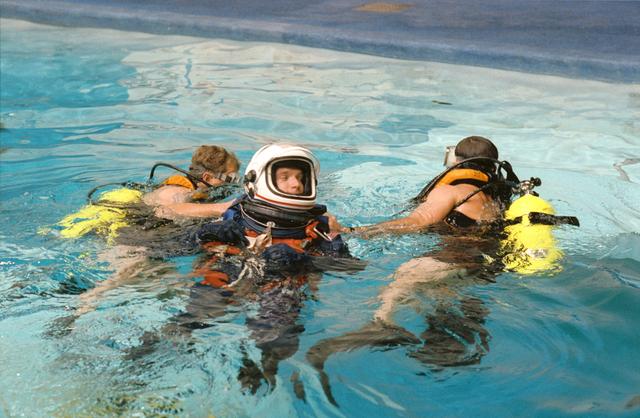 NASA image: STS-55 MS2 Precourt is assisted by divers during water egress training at JSC