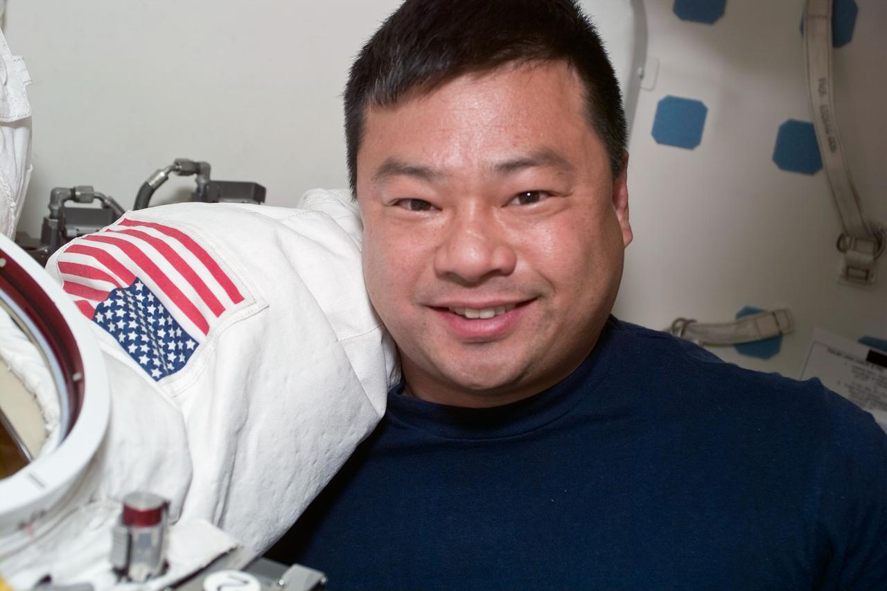 S92-E-5023 (12 October 2000) --- Electronic still camera's view features astronaut Leroy Chiao, mission specialist, in Discovery airlock with extravehicular mobility unit (EMU) space suit.