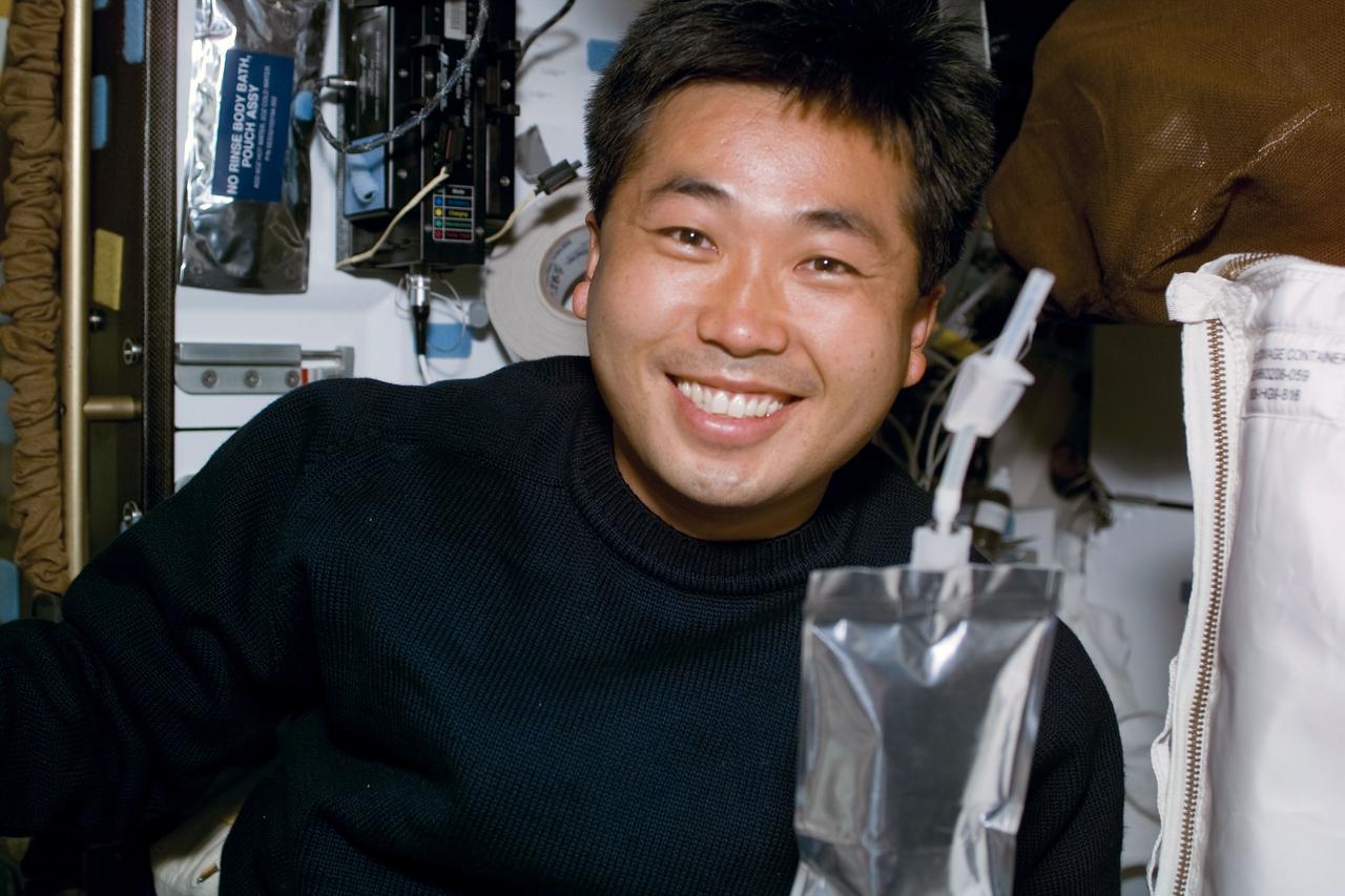 S92-E-5029 (12 October 2000) --- Astronaut Koichi Wakata, sought energy from a soft beverage packet prior to fulfilling an important role with the four scheduled STS-92 space walks and his other duties. From the shirt sleeve environment of the the Space Shuttle Discovery, the mission specialist who represents Japan's National Space Development Agency (NASDA), went on to man the controls for the remote manipulator system (RMS) or robot arm, to assist the four space walkers as they worked on the International Space Station (ISS). This photo was recorded with an electronic still camera (ESC) on Flight Day 2.