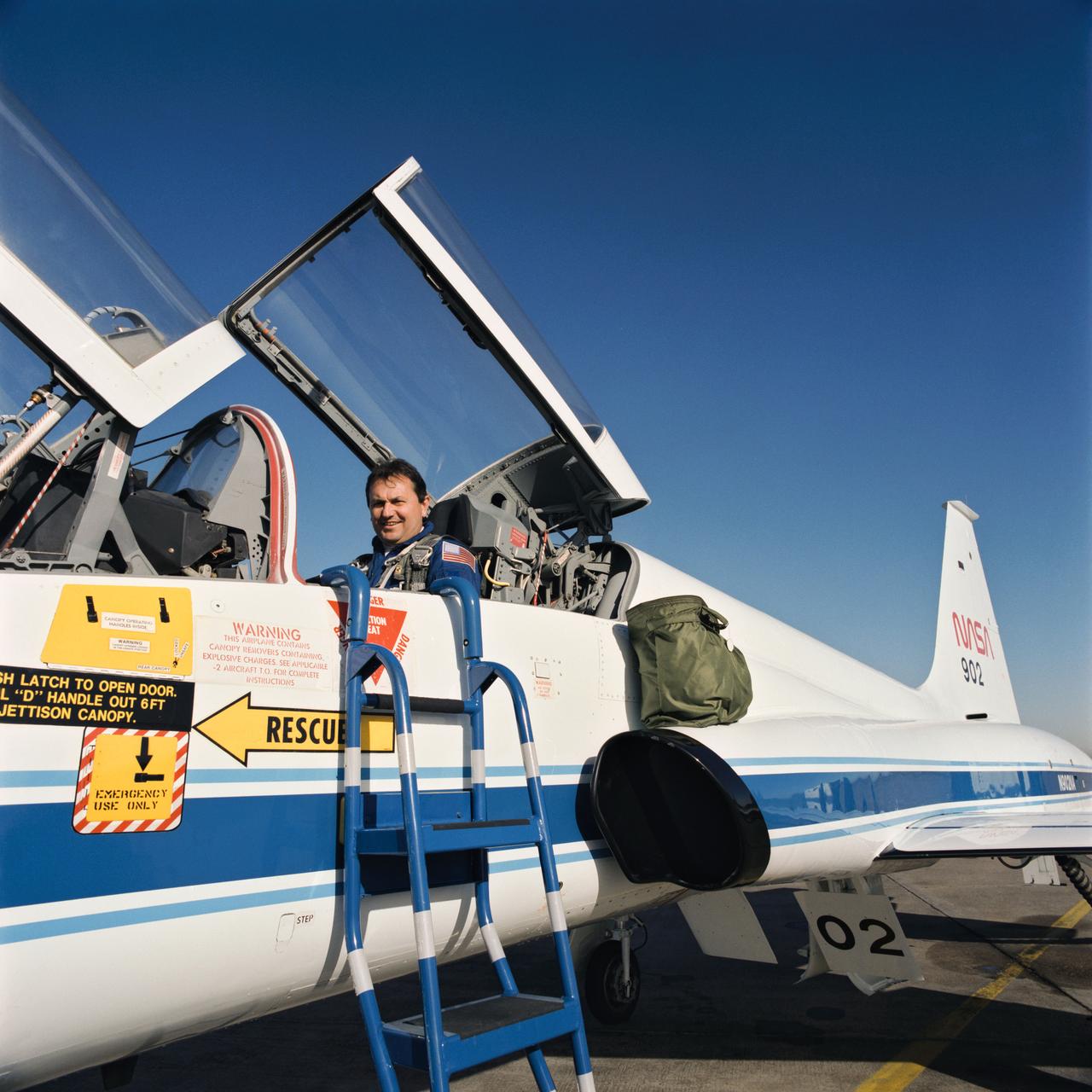 Seated in the rear station of a NASA T-38 jet trainer aircraft, Russian Cosmonaut Vladimir Titov prepares to take a familiarization flight.