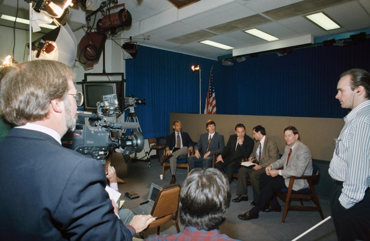 Three members of the STS-60 crew and an alternate crew member discuss their upcoming mission with the news media in JSC's public affairs facility. Seated from the left are Charles F. Bolden Jr., mission commander; Russian Cosmonaut Sergei Krikalev, mission specialist; Russian Cosmonaut Vladimir Titov, alternate mission specialist; interpreter Vladimir Fischel and Astronaut Kenneth S. Reightler, pilot.