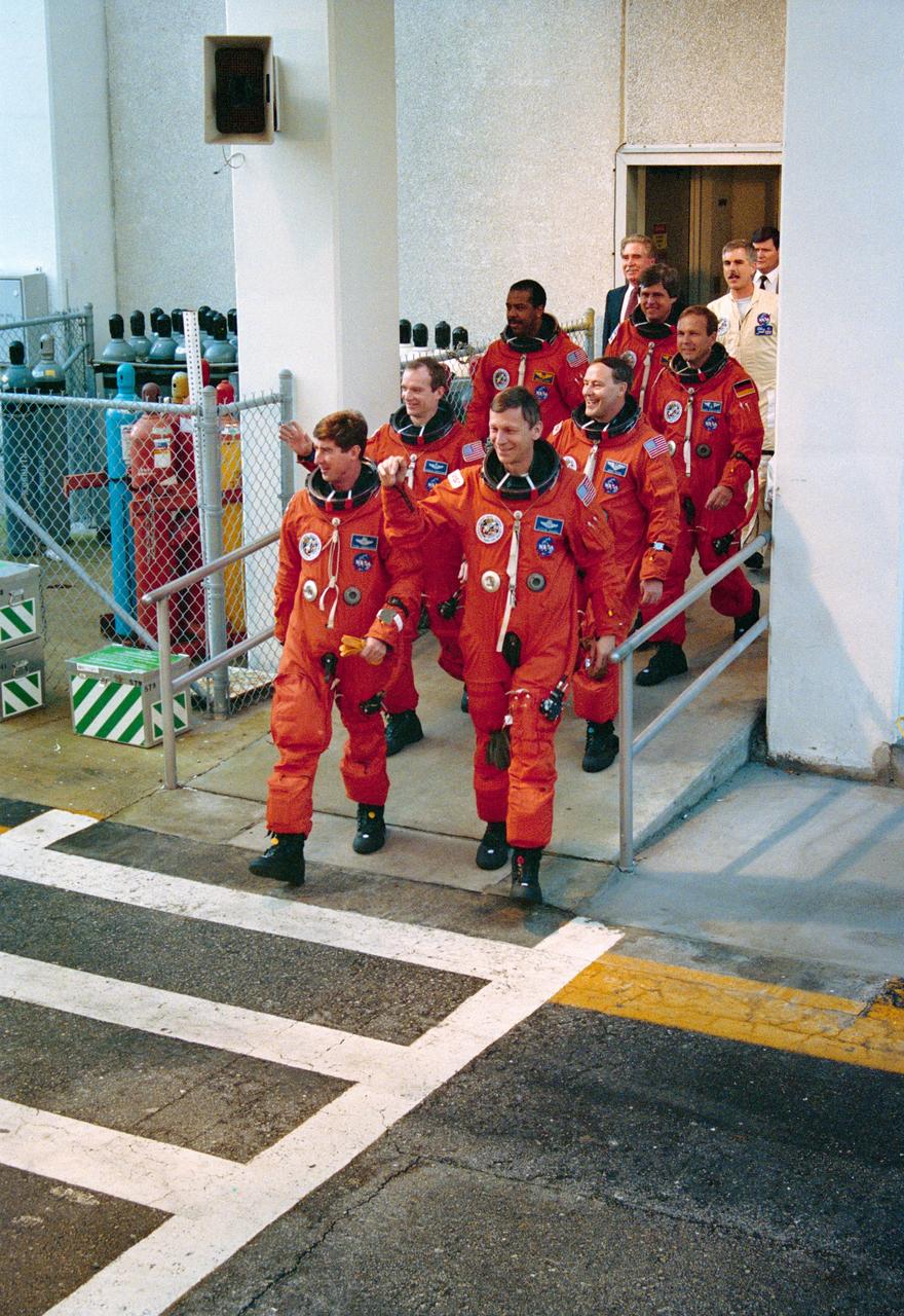 S93-29851 (12 Feb 1993) --- Clad in their bright orange launch/entry suits, the STS-55 flight crew departs the Operations and Checkout Building for the Space Shuttle Columbia at Launch Pad 39A.  Leading the way are Pilot Terence T. Henricks (left) and Mission Commander Steven R. Nagel; behind them are, from left, Mission Specialists Charles J. Precourt and Bernard A. Harris Jr.; Payload Commander Jerry L. Ross; and Payload Specialists Ulrich Walter and Hans Schlegel.  This is the final portion of the Terminal Countdown Demonstration Test, a dress rehearsal for launch which culminates with a simulated T -0.