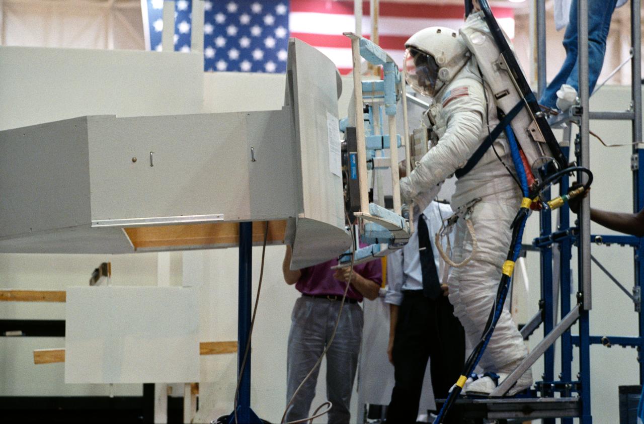 S93-35696 (7 June 1993) --- Making use of the air-bearing floor in Johnson Space Center's (JSC) Shuttle Mockup and Integration Laboratory, astronaut Jeffrey A. Hoffman practices working with the Hubble Space Telescope's (HST) Wide Field/Planetary Camera (WF/PC).  Hoffman is one of four mission specialists who will participate in HST servicing on the scheduled December mission.  Changing out the large camera is one of several chores to be performed by the four.  Photo credit: NASA