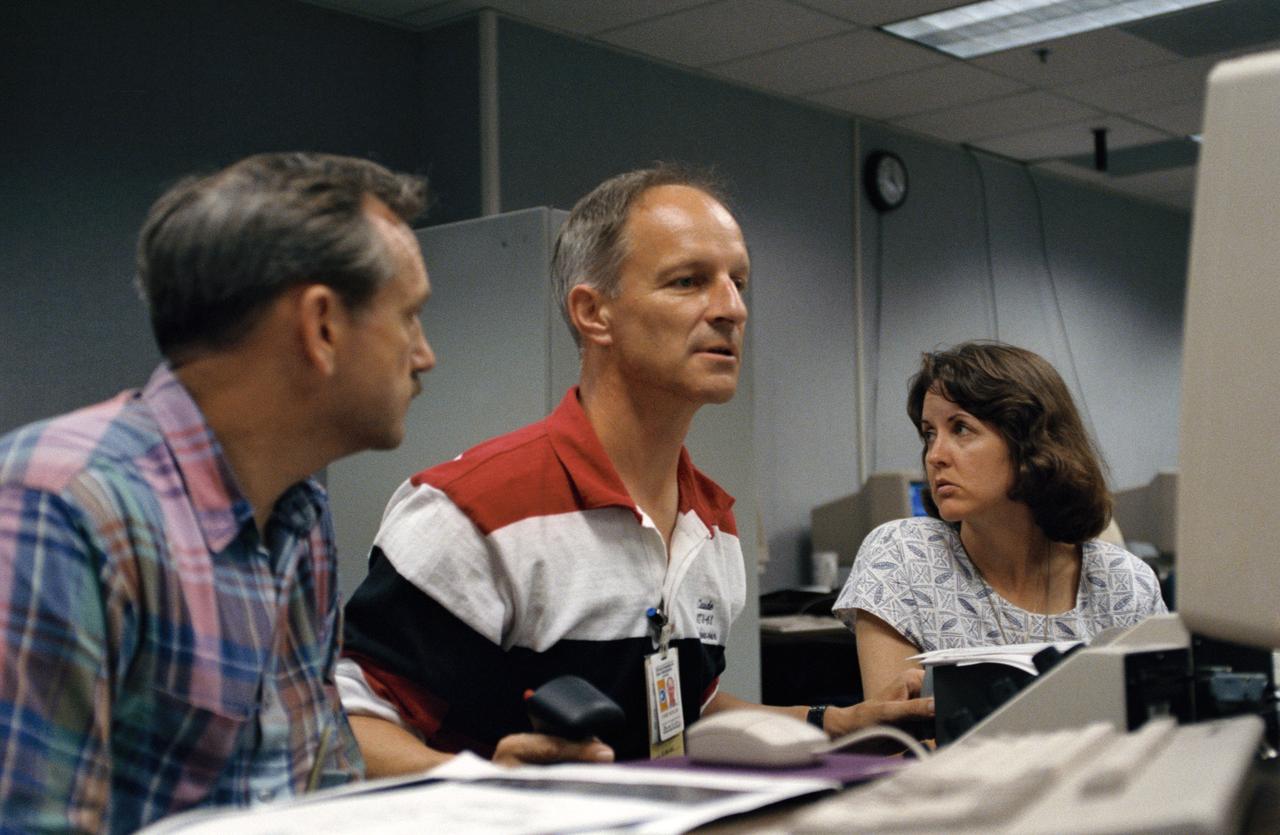 Astronaut Jeffrey A. Hoffman, one of four crewmembers for STS-61 that will conduct scheduled spacewalks during the flight, wears a special helmet and gloves designed to assist in proper positioning near the telescope while on the end of the robot arm. Crewmembers are utilizing a new virtual reality training aid which assists in refining positioning patterns for Space Shuttle Endeavour's Remote Manipulator System (RMS) (36890); Astronaut Claude Nicollier looks at a computer display of the Shuttle's robot arm movements as Thomas D. Akers and Kathryn C. Thornton, mission specialists look on. Nicollier will be responsible for maneuvering the astronauts while they stand in a foot restraint on the end of the RMS arm (36891,36894); Hoffman wears a special helmet and gloves designed to assist in proper positioning near the telescope while on the end of the robot arm (35892); Nicollier looks at a computer display of the Shuttle's robot arm movements as Akers looks on (36893); While (l-r) Astronauts Kenneth Bowersox, Kathryn Thornton, Richard O. Covey and Thomas D. Akers watch, Nicollier moves the Robot arm to desired locations in the Shuttle's payload bay using the Virtual Reality program (36895); Bowersox takes his turn maneuvering the RMS while mission specialist Hoffman, wearing the Virtual Reality helmet, follows his own progress on the end of the robot arm. Crewmembers participating during the training session are (l-r) Astronauts Akers, Hoffman, Bowersox, Nicollier, Covey, and Thornton. In the background, David Homan, an engineer in the JSC Engineering Directorate's Automation and Robotics Division, looks on (36896).