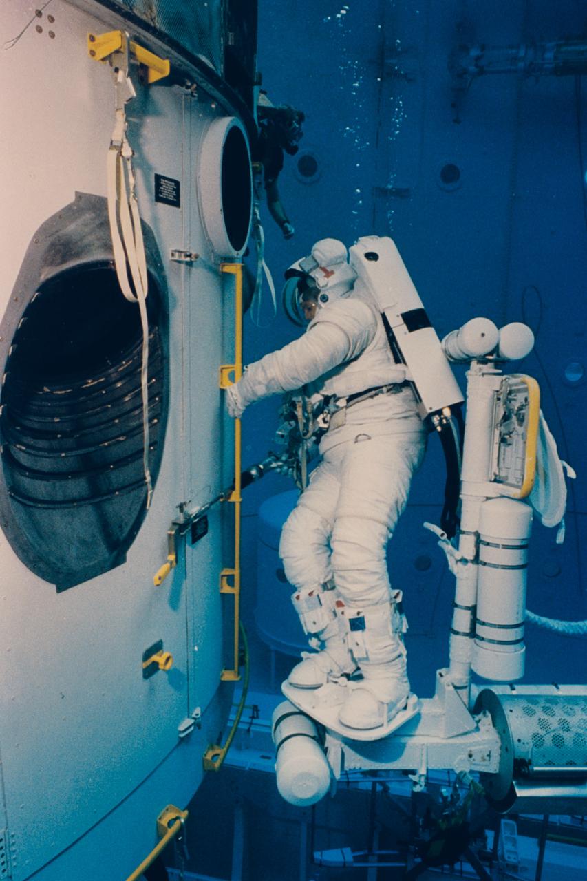 Astronaut Thomas D. Akers uses a power wrench to deploy one of the tools on the Hubble Space Telescope (HST) during a training session in the Neutral Buoyancy Simulator at Marshall Space Flight Center.