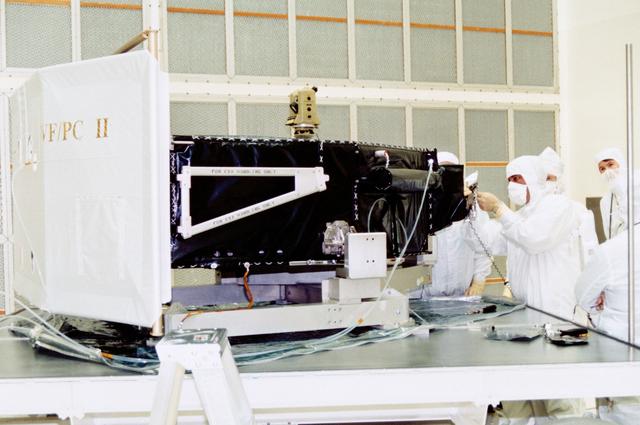 NASA image: Workers at Cape Canaveral install mirror in Wide Field/Planetary Camera II