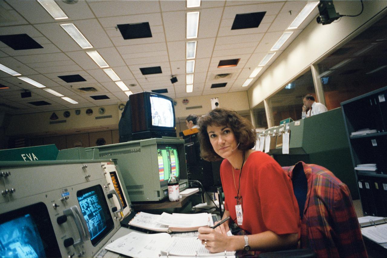 Susan P. Rainwater monitors an extravehicular activity (EVA) simulation from the EVA console at JSC's Mission Control Center (MCC) during joint integrated simulations for the STS-61 mission. Astronauts assigned to extravehicular activity (EVA) tasks with the Hubble Space Telescope (HST) were simultaneously rehearsing in a neutral buoyancy tank at the Marshall Space Flight Center (MSFC) in Alabama.