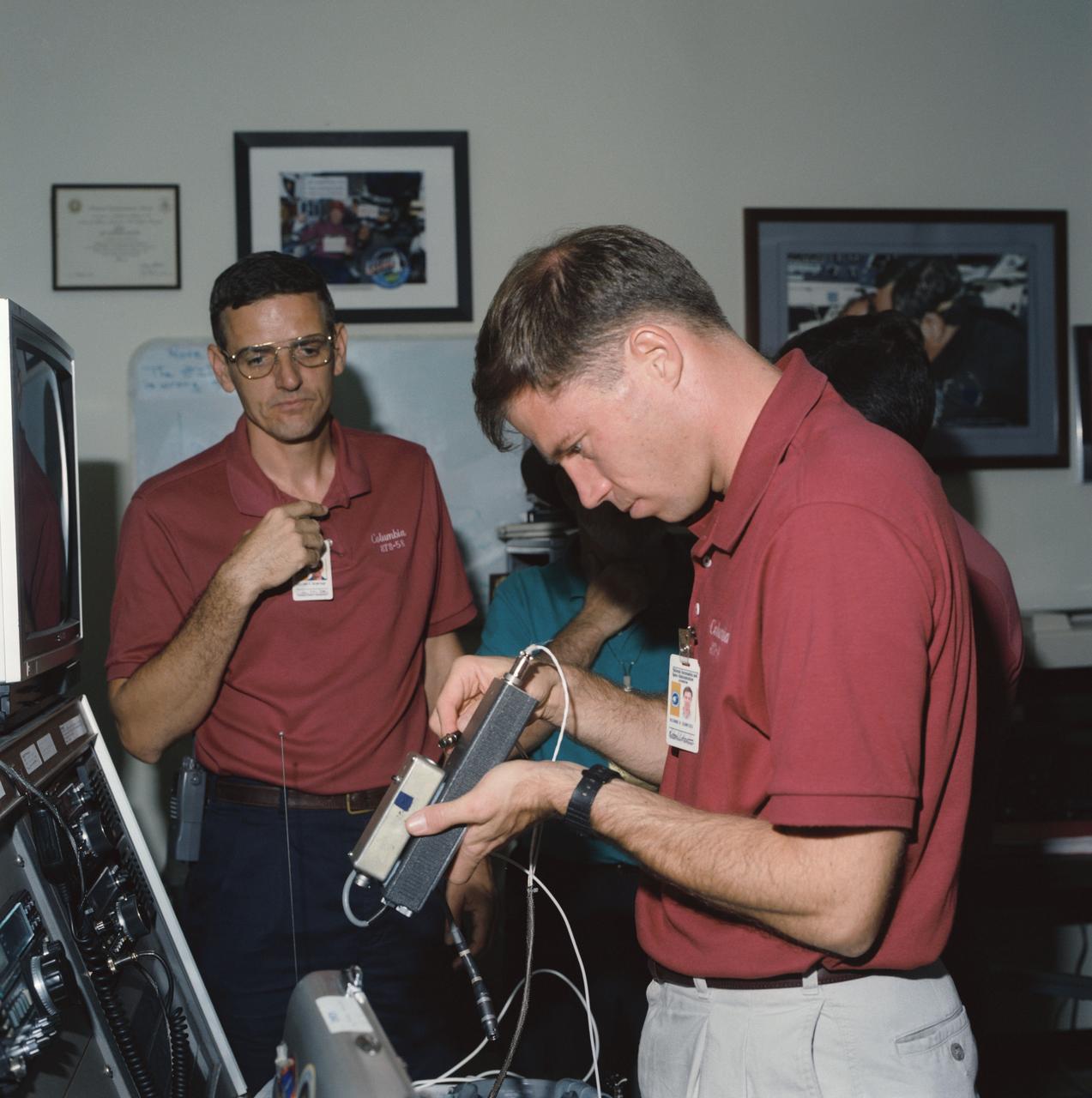 S93-45068 (22 Sept 1993) --- Two members of the STS-58 Spacelab Life Sciences (SLS-2) crew, train with amateur radio equipment at the Johnson Space Center (JSC).  They are William S. McArthur (left), mission specialist, and Richard A. Searfoss, pilot.  The STS-58 flight will carry the Shuttle Amateur Radio Experiment (SAREX) payload, configuration C, which includes FM voice and packet.  Three of the seven crewmembers are licensed amateur radio operators.  Searfoss' call letters are KC5CKM; McArthur, KC5ACR; and payload specialist Martin J. Fettman, KC5AXA.  Licensed students at a number of schools around the country will have the opportunity to talk directly with the astronauts during the 14-day flight.