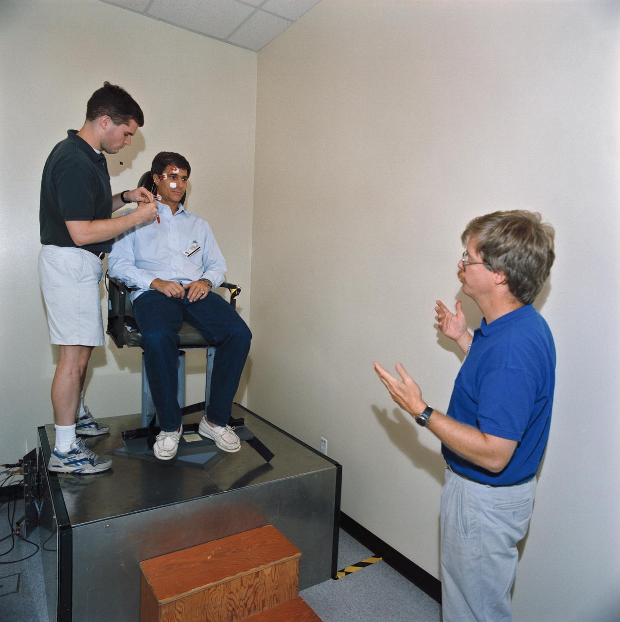 S93-45366 (29 Sept 1993) --- Astronaut John E. Blaha, STS-58 mission commander, sits in a training version of the rotating chair test device.  Sensors are attached to Blaha's head and face to record responses to the rotation.  Blaha was participating with five other NASA astronauts and a payload specialist for data collection and training in preparation for the two week Spacelab Life Sciences (SLS-2) mission.