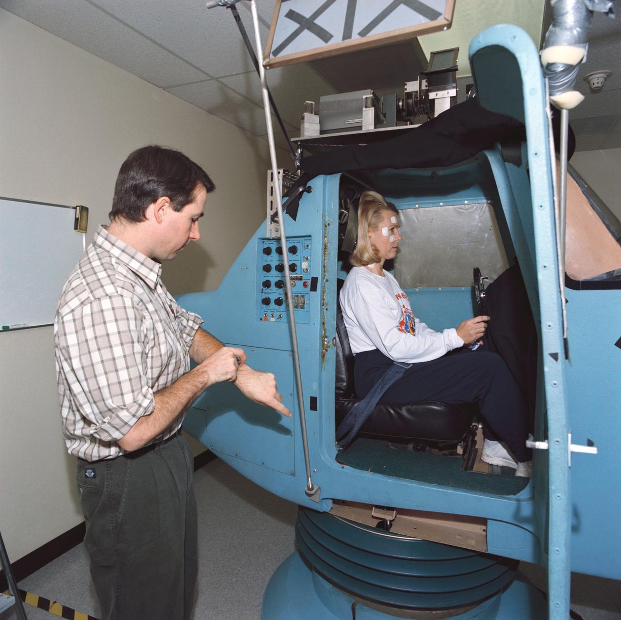 S93-45373 (29 Sept 1993) --- Astronaut Rhea Seddon, STS-58 payload commander, is in a piloting simulator as part of a pre-flight data collection project for neurovestibular functions.  The seven Spacelab Life Sciences (SLS-2) crew members devoted a full day to miscellaneous biomedical data collection in preparation for next month's two week mission aboard Columbia.