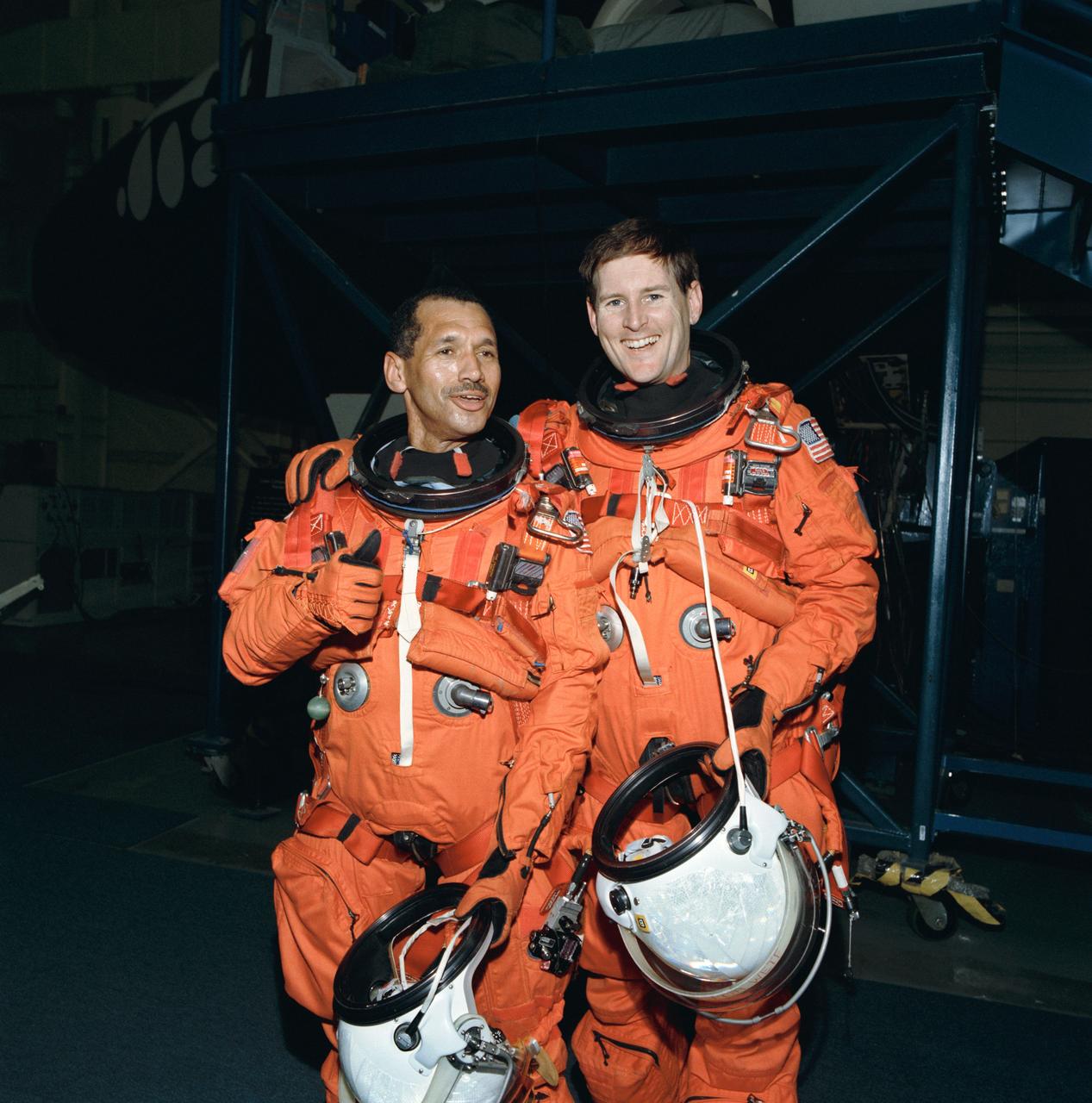 Astronauts Charles F. Bolden Jr. (left) and Kenneth S. Reightler, commander and pilot, respectively, for the STS-60 mission, take a break during rehearsal for some of their flight duties near the crew compartment trainer in JSC's Shuttle mock-up and integration laboratory (50648); Cosmonaut Sergei Krikalev, mission specialist for STS-60, gets assistance with his launch and entry suit from Lockheed's Max Kandloer during a training session. Others pictured, left to right, are Astronauts Franklin R. Chang-Diaz, Ronald M. Sega and N. Jan Davis (50649); Astronaut Kenneth S. Reightler, pilot for STS-60, gets assistance with his launch and entry suit (LES) from Boeing's William Todd during a training session (50650).