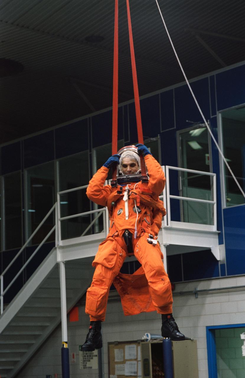 S93-50718 (22 Dec 1993) --- Astronaut Sidney M. Gutierrez, commander, is suspended by his parachute gear during emergency bailout training at the Johnson Space Center's (JSC) Weightless Environment Training Facility (WET-F).  Gutierrez and five other NASA astronauts are scheduled to fly aboard the Space Shuttle Endeavour next year.